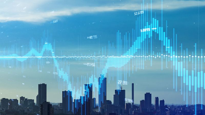 City skyline with digital financial graph overlay, illustrating data trends and urban economic growth.